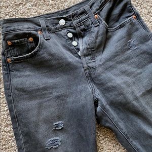 Charcoal gray distressed Levi’s 501 jeans